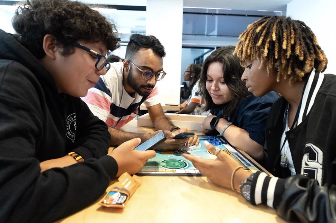 Young creators sharing a tabletop game activity.